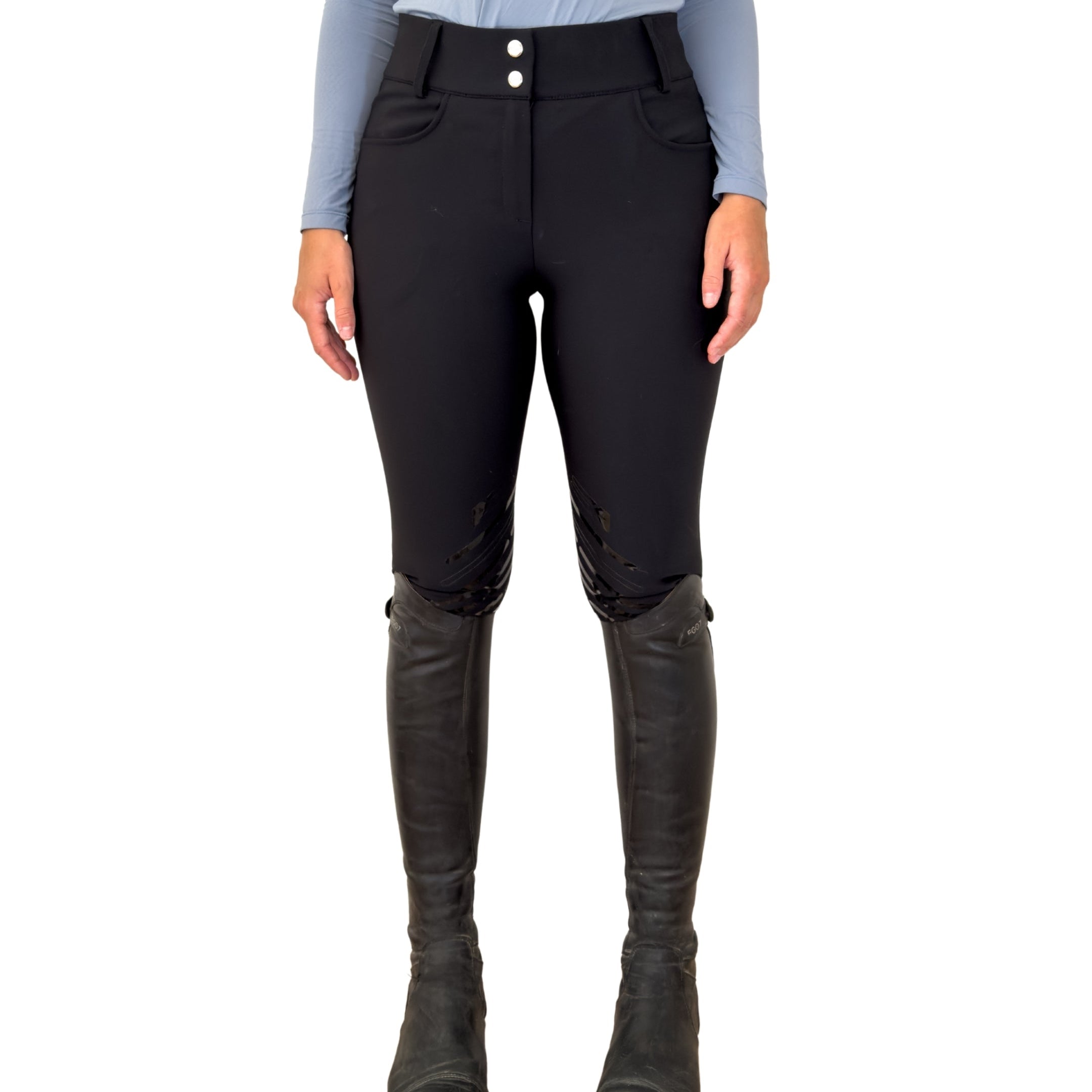 Person wearing black riding pants and boots on a white background